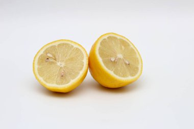 Taze, olgun, izole, sulu beyaz bir arka plan üzerinde limon ikiye bölünmüş. Stüdyo makro çekimi