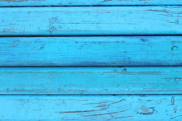 Çivili tahtaların yüzeyi maviyle boyanmış. Arkaplan resmi