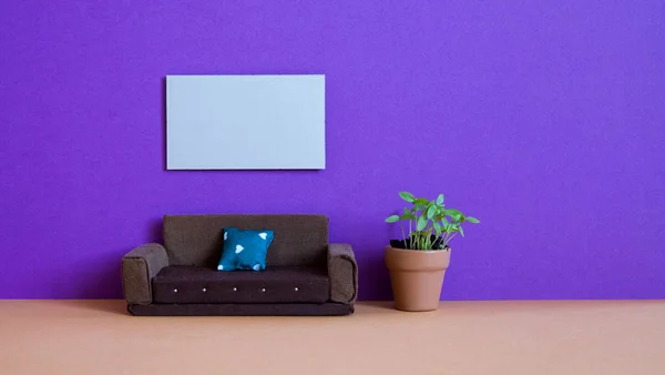 Minimalist living room furniture interior. Simple design brown sofa, flowerpot green plant and blank poster template on violet wall.