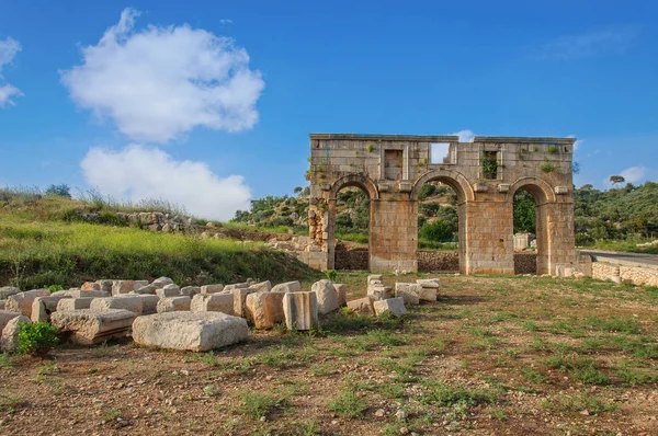 The well preserved ancient triple arched Triumphal Arch located at entrance to the Patara ancient city, Turkey