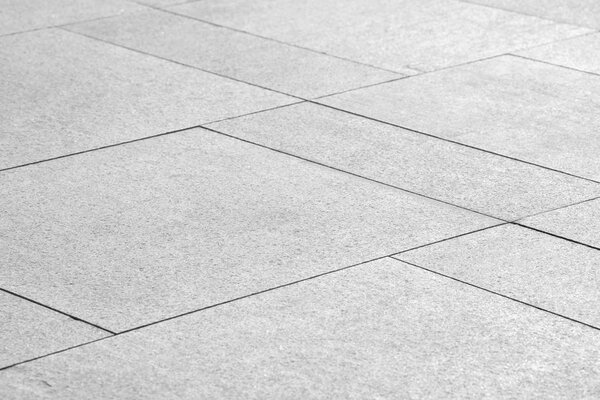 Paving stones background. Road texture black and white. Stone flooring. Stone covering on the square.