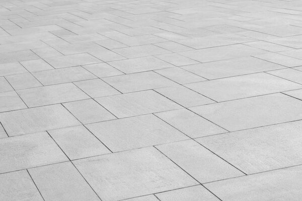Paving stones background. Road texture black and white. Stone flooring. Stone covering on the square.