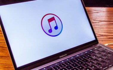 Dallas, Texas/ United States - 06/7/2018: (Photograph of the itunes logo on computer screen) clipart