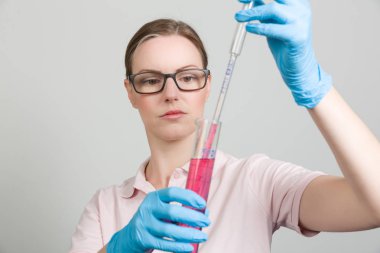 bir test tüpünde bir laboratuvar ile kadın bilim adamı