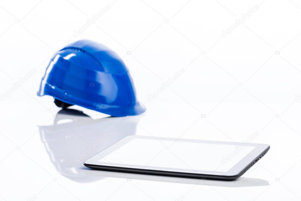 hard hat on white table with a pad