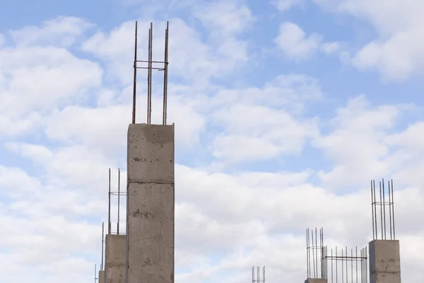 construction site with new concrete columns reinforcing steel