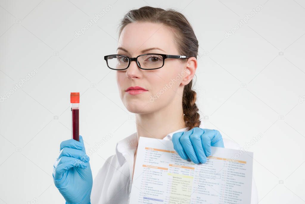 young woman holding at blood probe in laboratory