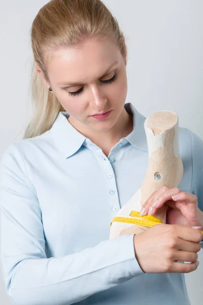 Female Orthopedic Shoemaker Holds Handmade Wooden Last Fron — Stock Photo, Image