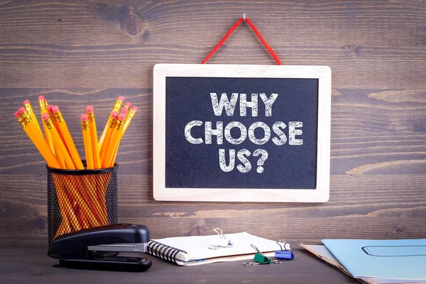 Why choose us. Chalkboard on a wooden background — Stock Photo, Image