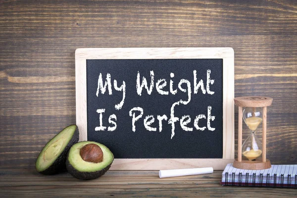 my weight is perfect. Fitness, healthy eating and veganism. Chalkboard on a wooden background