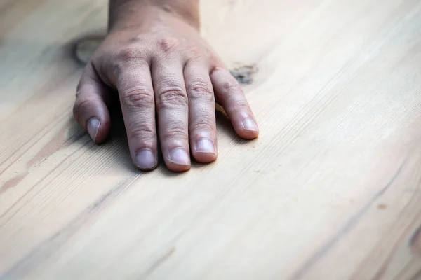 Hand on a wooden background — Stock Photo, Image