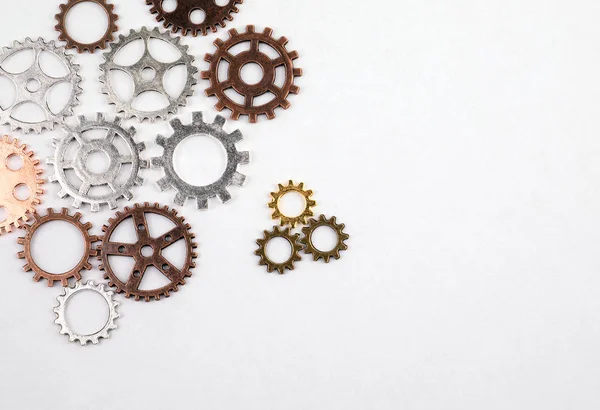 Different sizes and colored gears on a white background