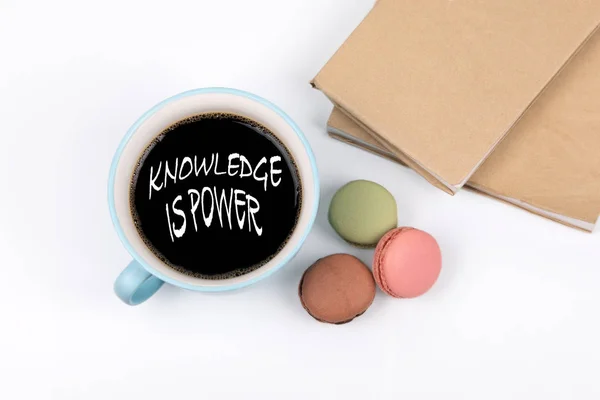 knowledge is power. coffee mug and macarons