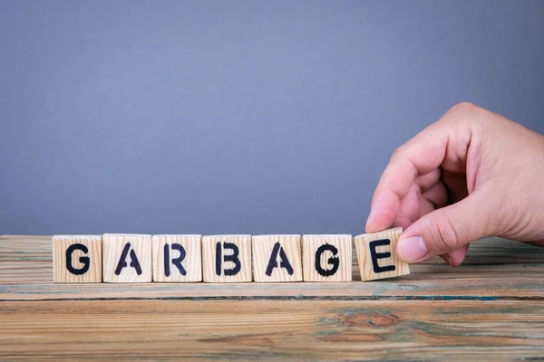 garbage. Wooden letters on the office desk