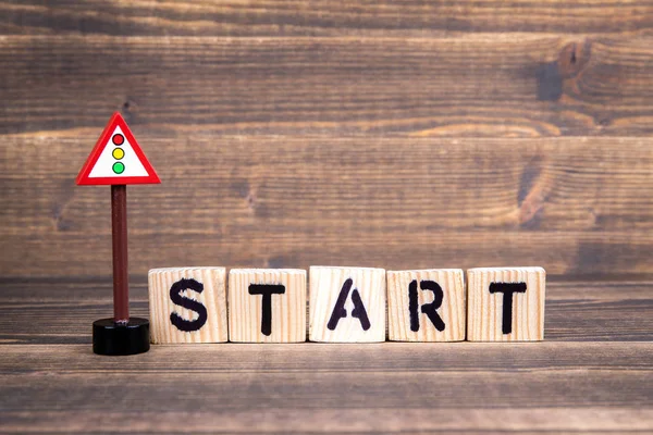 Start Name from wooden letters with a traffic light road sign — Stock Photo, Image