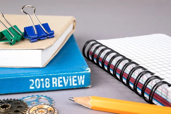 2018 review concept. blue book on a gray office table
