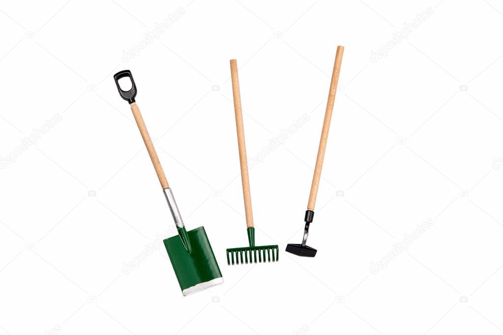 Small gardening rake, hoe and shovel isolated on white