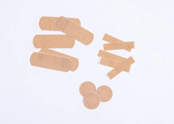 Set of adhesive plasters on white background