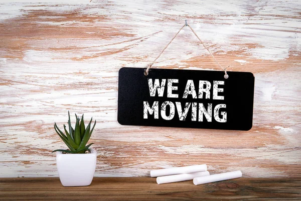 We Are Moving. Small blackboard on the wall with text — Stock Photo, Image