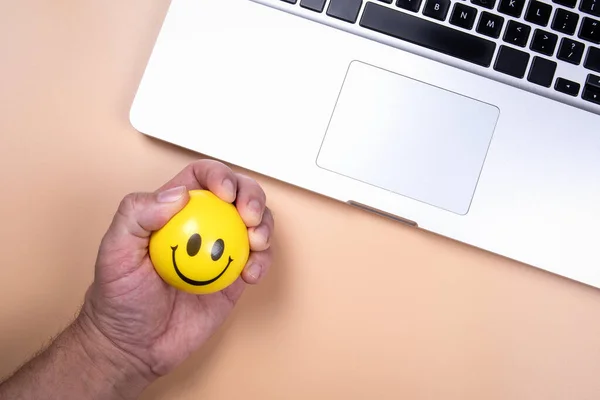 Hand squeeze yellow stress ball. Overload, health problems and depression