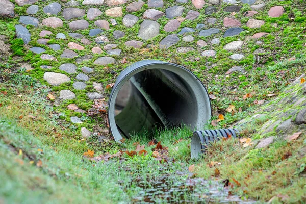 Drainage pipe. Culvert under small road.
