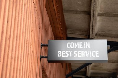 En iyi servis konseptiyle gelin. Binanın duvarında reklam panosu var.