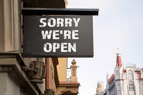 SORRY WERE OPEN. Shop, cafe, restaurant or hotel signboard. City center and old town