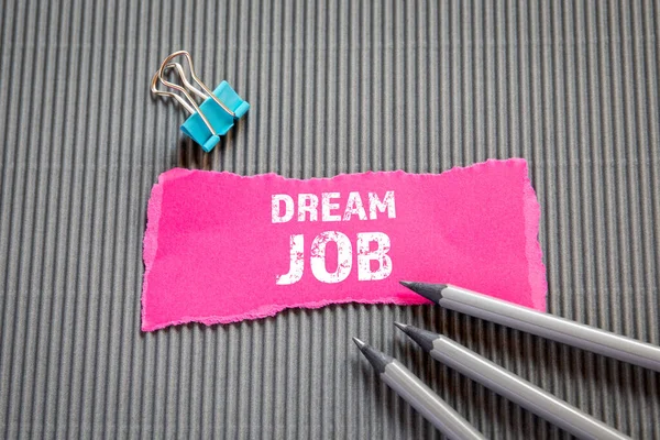 DREAM JOB. Career, education and job interview concept. Text on torn, colored paper