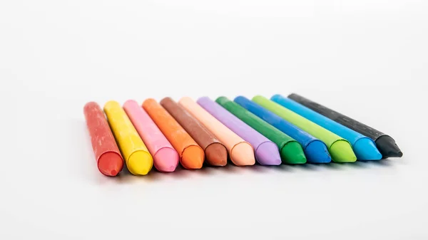 Colored pastel crayons on a white background. creativity, learning, arts and childrens entertainment — Stock Photo, Image