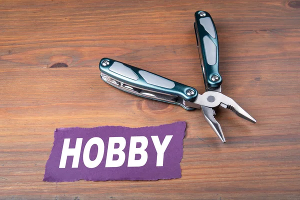 HOBBY concept. Holidays, recreation and homework. Pliers on wooden table