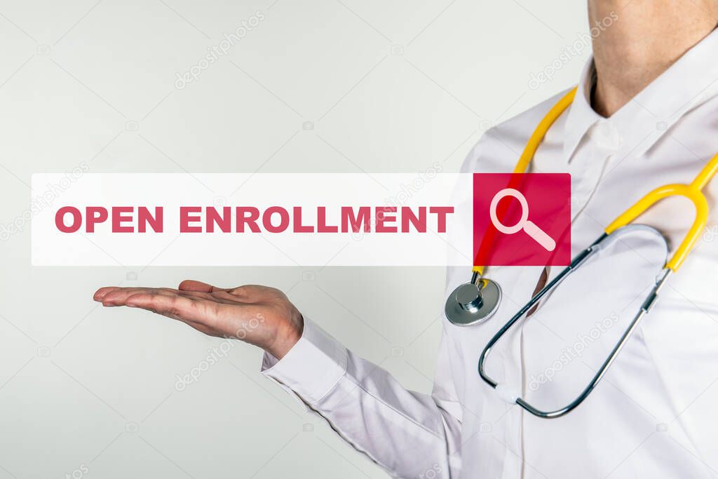 OPEN ENROLLMENT. Female doctor with stethoscope. Searching for information on the Internet