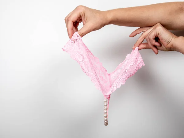 Pink womens panties with beads. romance, sexual relations, hygiene and health concept — Stock Photo, Image