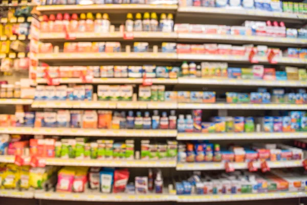 Eczane deposu ile ilaç ve tıbbi sarf malzemeleri ürün rafları ekranda etiketindeki görücü usulü varyasyonu içinde arka plan bulanık. İlaç deposu bulanık ilaçlar ile kapalı alanı.