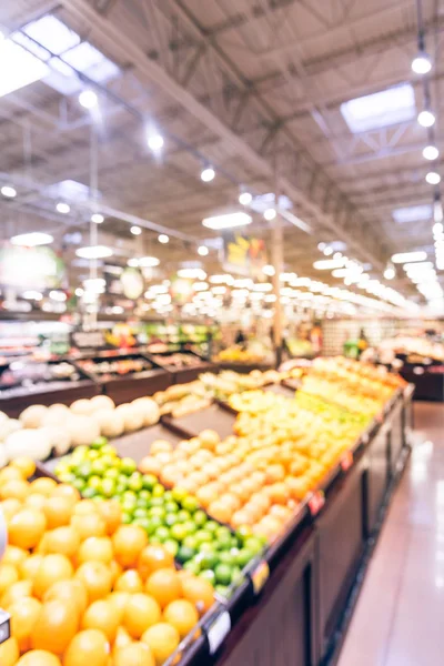 Vintage blur abstract organic fresh produces, fruits and vegetable on shelves in store at Humble, Texas, US. Blurred supermarket, grocery with customers shopping and bokeh light background