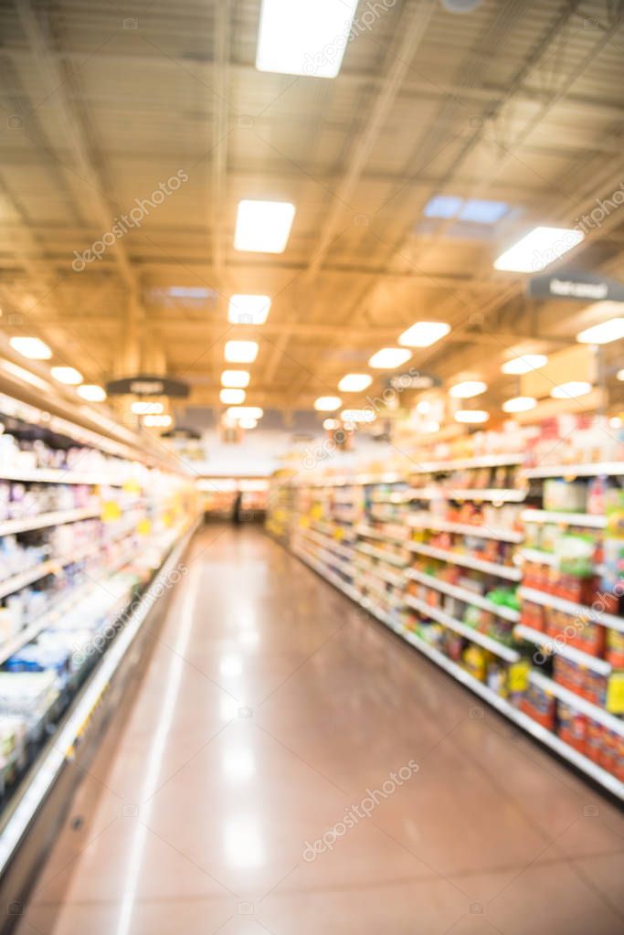 Abstract blurred fridge shelves with full of yogurt at grocery s