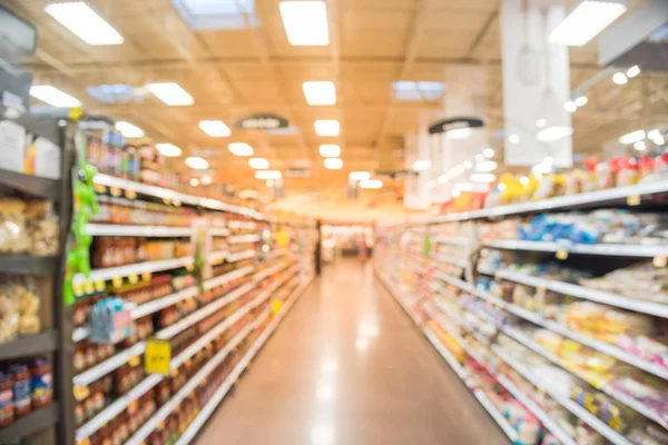 Blurred sauces, buns, rolls, snack, cakes, tortillas, Latin, America, foods, salsa, dips aisle in store at Humble, Texas, US. Wide perspective view shelves variety of foods, defocused blur background