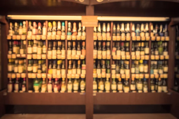 Vintage bulanık büyük çift kişilik şarap koridorda mağazasında Houston, Texas, soğutulmuş şarap bölümünde bize. Şarap likör şişesi süpermarket ahşap raf ufuk satırı. Alkollü içecek arka plan