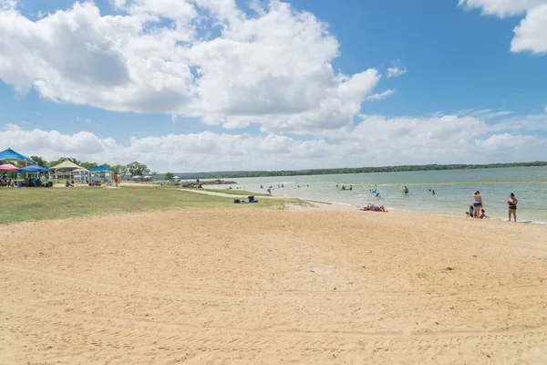 Texas, Usa-Haziran 16, 2018: waterfront Lynn Creek Park, Grand Prairie, Texas, güzel beyaz kum plaj. Yüzme, yüzen, grup kamp ve piknik lakeside çadırlar, bulut mavi gökyüzü, insanlar zevk
