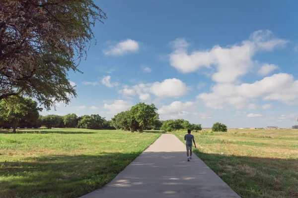 Arkadan görünüm etkin bir Asyalı adamın Park'ta sabahın erken saatlerinde koşu. Sağlıklı yaşam konsepti