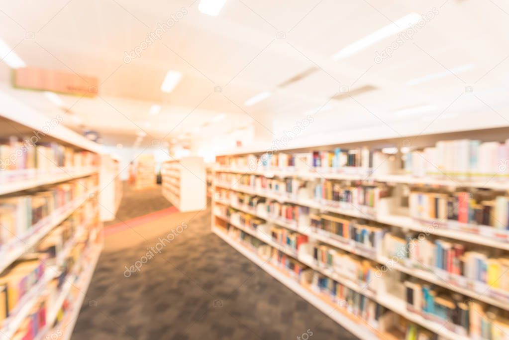 Blurred abstract background of modern public Asian library interior with bookshelf aisle full of textbooks, literature, thesis, magazines. Self-study, educational concept and background. Motion blur.