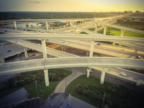 Vintage tone aerial view massive highway intersection, stack interchange with elevated road junction overpass in Houston, Texas, USA. Five-level freeway interchange carry heavy rush hour traffic