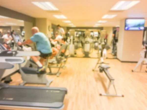 Blurred motion of fitness center with cardio machines, weight, strength training equipment, TV. Gymnasium facility service room in 3-star hotel in San Francisco, California, USA. Active lifestyle