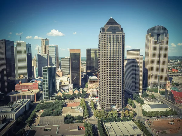 Downtown Dallas and financial district flyover. Construction site foundation equipments on the left. Aerial view modern skyscrapers under summer cloud blue sky. Metropolis and cityscape background