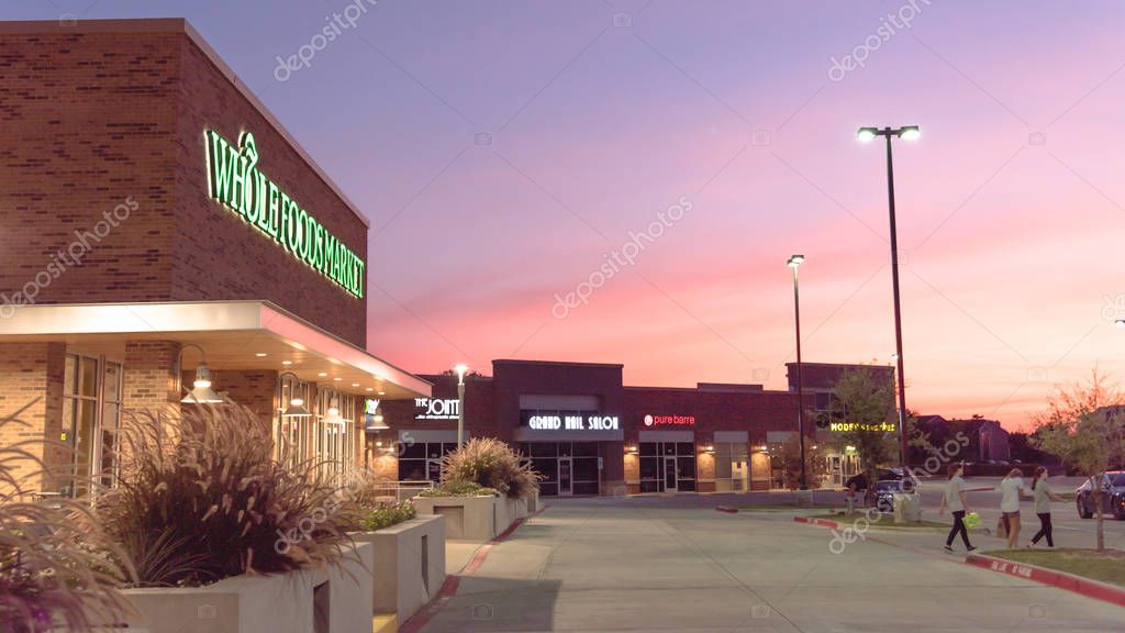 IRVING, TX, US- JUL 21, 2018:Customer walk out, exit Whole Foods Market store. Eco-minded supermarket chain featuring food without artificial preservatives, colors, flavors, sweetener, hydrogenated