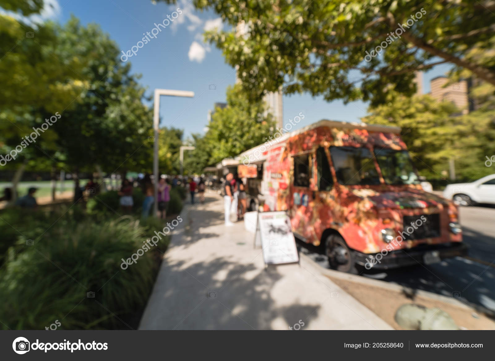 Blurred Food Truck Vendor Serving Near Urban Park In Dallas