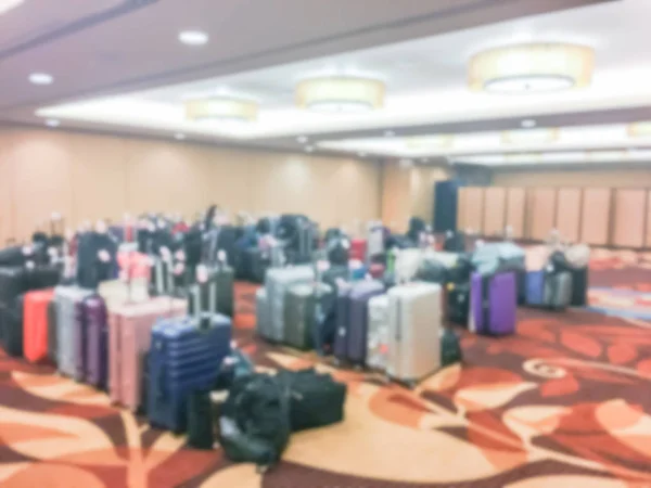 Blurred baggage storage room at a luxury hotel in San Francisco, California, USA. It is available for guests who want to leave bags. Defocused background collection of multicolor suitcase luggage