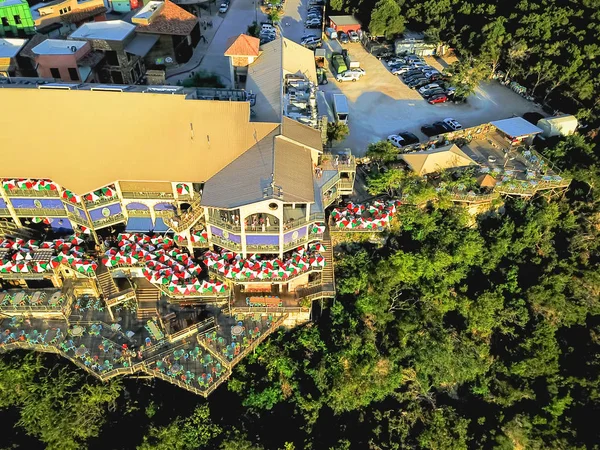 Aerial view restaurant with colorful umbrella decoration desk near bluffs cliff rock wall in America