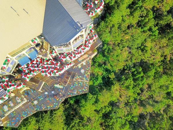 Aerial view restaurant with colorful umbrella decoration desk near bluffs cliff rock wall in America