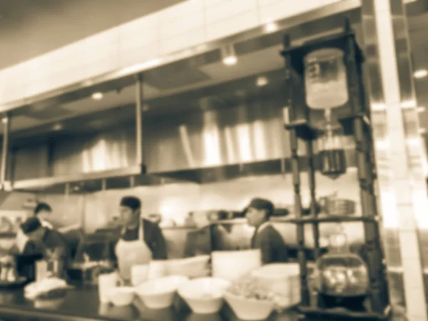 Vintage tone abstract blurred restaurant chefs cooking in the open kitchen of Asian restaurant. Glass cup cold drip maker straight black