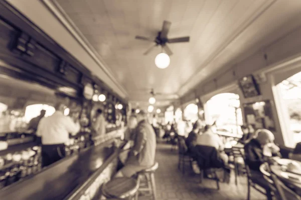 Vintage blurred abstract original Irish coffee restaurant in San Francisco, USA.  Bartender talking with customer at bar counter